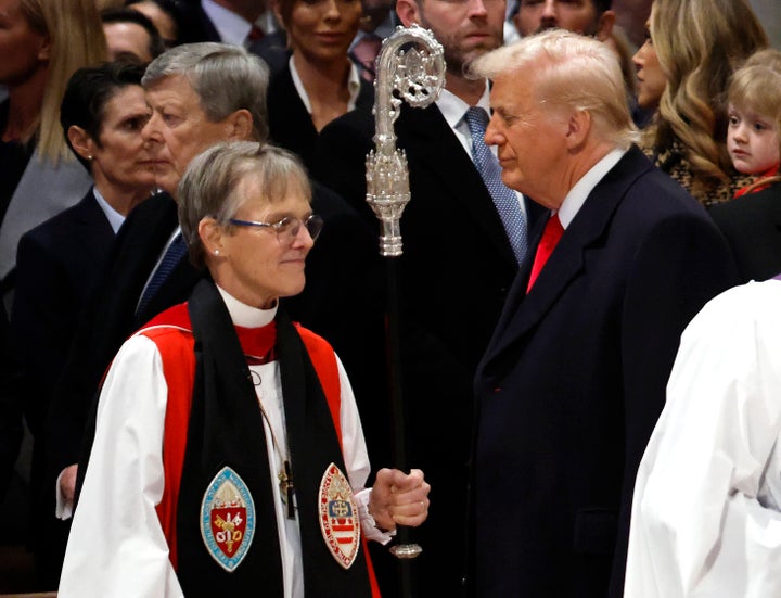 Bishop Mariann Edgar Budde (L) arrives as U.S. President Donald Trump looks on during the National Prayer Service at Washington National Cathedral on Jan. 21, 2025 in Washington, DC.