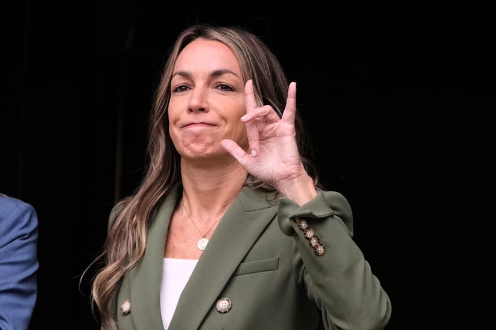 Karen Read gestures to her supporters while departing Norfolk Superior Court during jury deliberations at her trial, Tuesday, June 17, 2025, in Dedham, Mass.