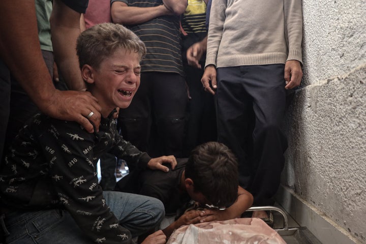 Relatives mourn over Palestinians who were killed in an Israeli attack on people waiting line for humanitarian aid, as the bodies get taken from Al-Shifa Hospital for their funeral in Gaza City, on June 18, 2025.